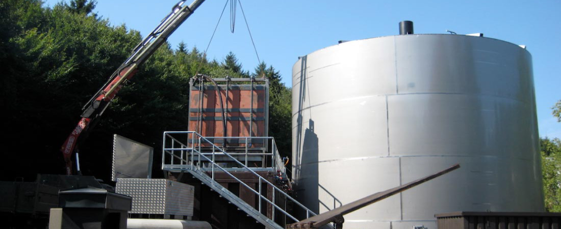 Image of crane lifting A3 MaxFlow membrane modules into wastewater treatment tank at a food production facility