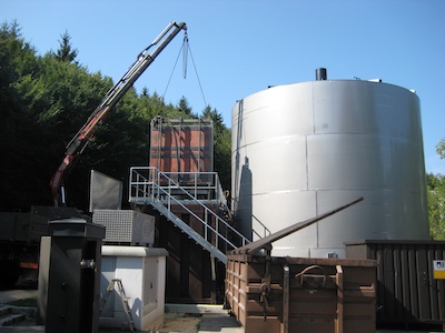 Image of a crane lifting A3 MaxFlow wastewater membrane modules into a wastewater tank at a food production facility