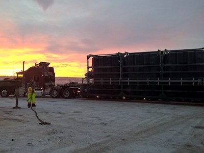 Image of a packaged A3 MBR wastewater treatment plant arriving at a job site in the Bakken oil fields