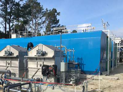 Image of a packaged A3 MBR wastewater treatment plant arriving at a job site in the Bakken oil fields